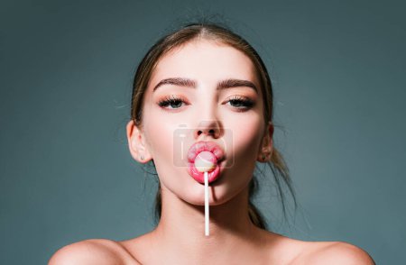 Photo for Sensual glamorous attractive lady licking yummy sugary lollypop with red lips. Girl sucks lollipop. Flirting sexy female pop art style. Portrait of sexy woman - Royalty Free Image