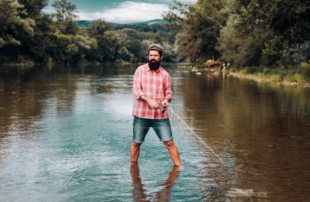 Photo for Fishing hobby and summer weekend. Bearded men fisher with fishing rod and net - Royalty Free Image