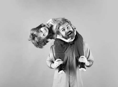 Photo for Fathers day. Father giving funny excited son piggyback. Happy family - Royalty Free Image