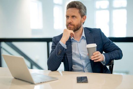 Photo for Serious business man working in office. Handsome business man in casual suit using laptop in office. Business man office worker in formal suit. Office manager ceo business man using laptop - Royalty Free Image