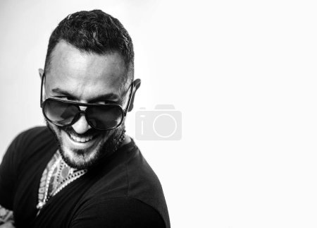 Photo for Portrait of stylish happy smiling handsome young man. Fashion guy with sunglasses - Royalty Free Image