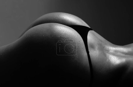 Foto de Close up buttocks, bikini thong underwear. Sexy ass in erotic lingerie. Woman sexy silhouette body in panties. Butt with sensual touch - Imagen libre de derechos