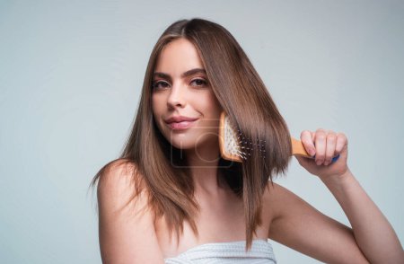Photo for Close up portrait of happy beautiful girl with shiny hair with comb. Attractive smiling woman brushing hair - Royalty Free Image