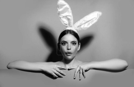 Photo for Easter bunny woman. Studio shot of a surprised young woman wearing rabbit ears - Royalty Free Image