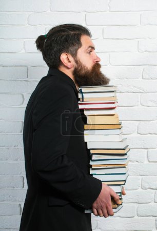 Photo for Portrait of a funny teacher or professor with book stack. Thinking serious mature teacher. Books stacked fall. Mature professor, middle aged teacher, bearded fun man - Royalty Free Image
