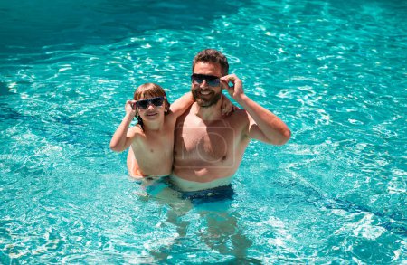 Photo for Father and son swimming in pool. Family at aquapark. Dad and son in pool. Summer weekend. Family leisure and summer vacation. Pool party - Royalty Free Image