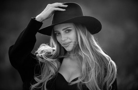 Photo for Beautiful girl face closeup, outside portrait of young woman in fashion brim black hat. Summer romantic casual woman. Lifestyle, walk outdoors, enjoying life, positivity - Royalty Free Image