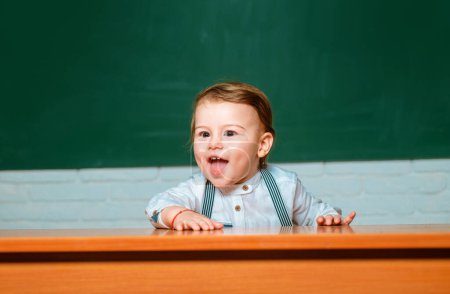 Photo for Preschool kids. Learning and education concept. Back to school. Funny preschooler on blackboard background - Royalty Free Image