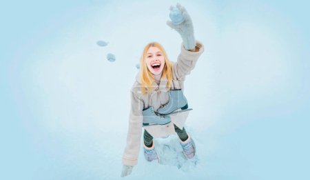 Photo for Girl throws snowballs. Snow games. Funny winter girl play with snow. Happy amazed girl in the snow make snowball. Winter activities in cold winter weather. Young girl laughing in snowy park - Royalty Free Image