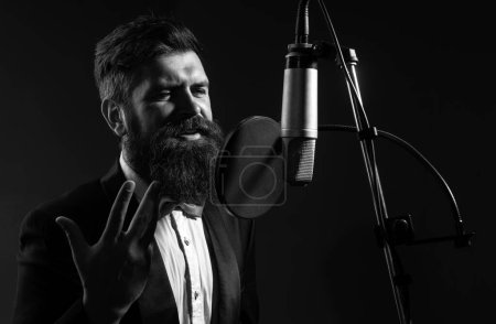 Photo for Singer singing classical music. Sound producer recording song in a music studio. Excited Karaoke - Royalty Free Image