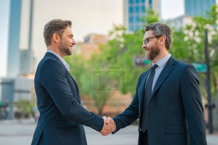 Photo for Handshake with partner in the city for greeting. Two businessmen shaking hands outdoor. Business mens growth strategy. Business men with proposal to the client. Handshake between two businessmen - Royalty Free Image