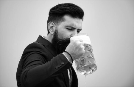 Photo for Hipster with beard and mustache in suit drinks beer after working day. Germany Bavaria. Beer time. Handsome barman holding a pint of beer - Royalty Free Image