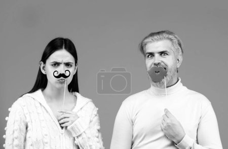 Foto de Concepto de género. Identidad transgénero, estereotipos de género. Un par de mujeres con bigote y un hombre con labios rojos. Igualdad de género - Imagen libre de derechos