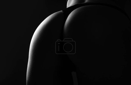 Foto de Sexy big ass in erotic lingerie closeup. Great ass. Sexy female wearing pants. Sexual girl takes off underwear. Seductive woman with beautiful butt, undressed and stripper concept - Imagen libre de derechos