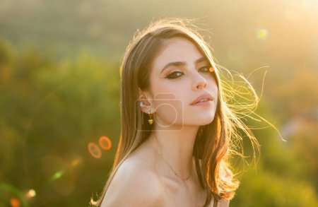 Photo for Natural female beauty. Young woman with clean fresh skin. Sensual portrait of elegant young woman outdoors. Young woman outdoor enjoying the sunlight - Royalty Free Image