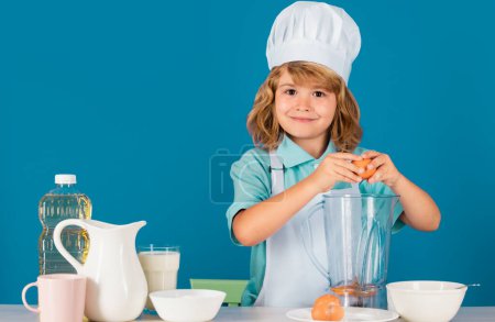 Photo for Cooking children. Chef kid boy making fresh vegetables for healthy eat. Portrait of little child in form of cook isolated on grey background. Kid chef. Cooking process - Royalty Free Image