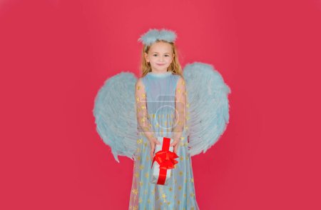 Photo for Little kids angel with present gift. Little angel with white wings holds gift. Cute angel child girl with angels wings, isolated on red. Valentine gift card - Royalty Free Image