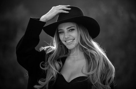 Photo for Close up face of young stylish woman in wide broad brim hat. Beautiful fashionable girl outdoor portrait. Happy smiling woman with romantic smile - Royalty Free Image