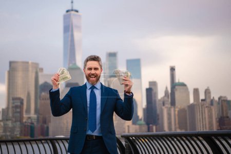 Photo for Businessman hold money dollars in New York. Businessman with dollar outdoor. Wealth rich businessman millionaire in suit holding money dollars . Winner, success with dollars. Finance and banking - Royalty Free Image