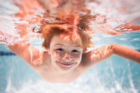Photo for Funny kids face under water. Children playing in swimming pool. Underwater. Child in the swimming pool. Cute kid boy swimming in pool under water - Royalty Free Image
