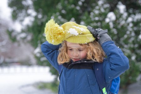 Photo for Child snowball fight in snow. Winter holiday kids snow activity. Child enjoy Christmas vacation. Kid in winter clothes in snowy forest. Trees covered white snow. Kid have fun playing snow snowball - Royalty Free Image