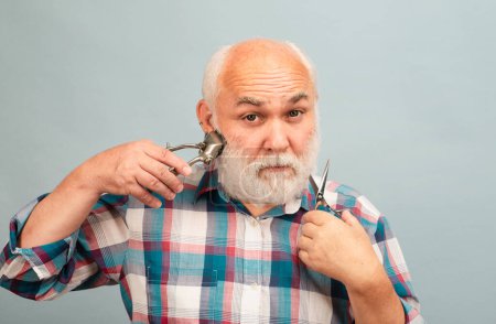 Photo for Middle aged hairdresser man. Barber scissors and straight razor hair clipper, Vintage barber shop, shaving. Portrait old bearded man. Vintage barbershop - Royalty Free Image