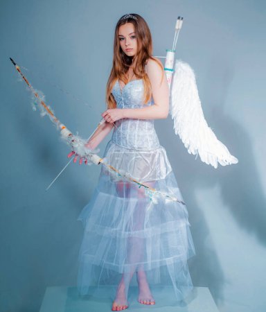 Photo for Angel girl with blonde hair. Teenager Cupid. Valentines day. Girl dressed as an angel on a light background. Concept of innocent girl - Royalty Free Image