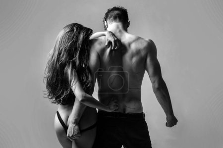 Photo for Sexy beautiful girl scars boyfriends back with nails. Sadism and masochism concept, foreplay games. Sexy hot loving couple isolated at grey background. Painful love. Love scars - Royalty Free Image