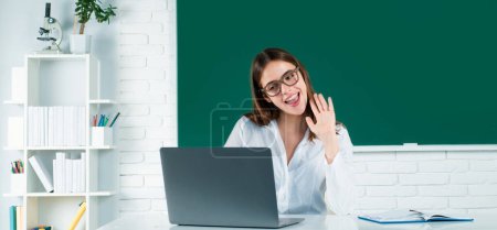 Photo for Portrait of a young, confident and attractive female student with laptop computer in school classroom. Online learning at school, distance education - Royalty Free Image
