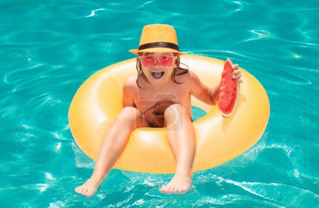 Photo for Child with watermelon swim with inflatable ring in swimming pool. Tropical resort for kids - Royalty Free Image