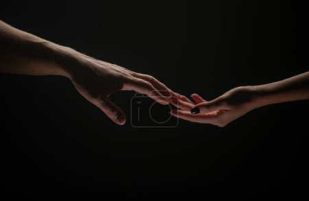 Foto de Hands at the time of rescue. Friendly handshake, friends greeting, teamwork, friendship. Rescue, helping gesture or hands. Romantic touch with fingers, love - Imagen libre de derechos