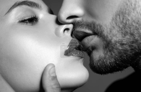 Photo for Close-up of beautiful passionate couple kissing. Young lovers closing to kiss. Woman smelling mans perfumes. Sexy Aroma. Sensual kisses. Profile side view, cropped macro of face - Royalty Free Image