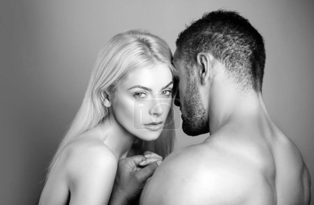 Photo for Couple Tender passion. Pretty beautiful woman and her handsome stylish boyfriend. Half naked young couple is making love, tender and romantic. I love when hes kissing of me neck - Royalty Free Image