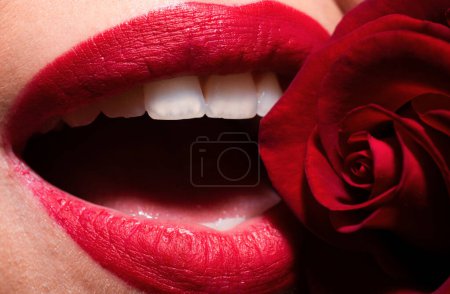 Photo for Beautiful woman lips with red matt lipstick. Open mouth with white teeth. Passionate mouth. Beautiful woman lips with rose - Royalty Free Image