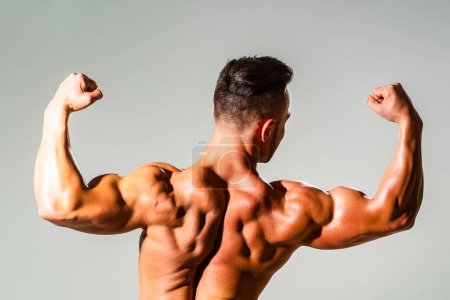 Photo for Strong Sexy Athletic Man. Fitness Model showing naked Back. Man Power. Perfect Shoulders and Back Muscles. Muscular Man showing Strength, Back view. Sexy body. Strong Power Shoulders - Royalty Free Image