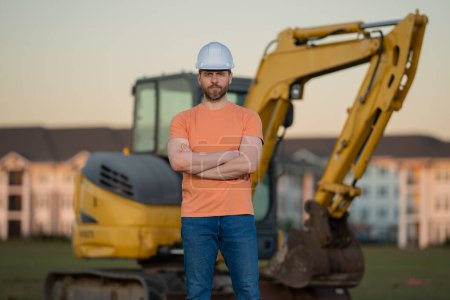 Photo for Worker at construction site. Builder in hardhat. Construction man with helmet. Worker at construction with helmet. Industry worker at construction building. Builder at site building with excavator - Royalty Free Image