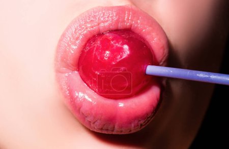 Photo for Sucking lips. Mouth licking lollipop, red female glossy lips and pink candy lollipop - Royalty Free Image