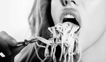 Photo for Close up sexy lips with noodles pasta. Female mouth eat spaghetti - Royalty Free Image
