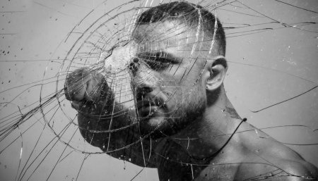 Photo for Sexy hispanic tattooed man behind broken glass. Bullet hole in glass. Destruction and crush test concept. Man style. Macho man glasscutter behind crushed glass - Royalty Free Image