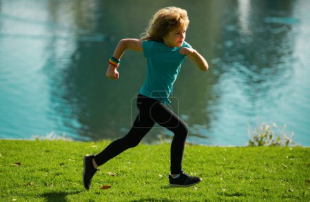 Photo for Kids jogging in park outdoor. Little boy running in nature. Active healthy child boy runner jogging outdoor. Morning running with children - Royalty Free Image