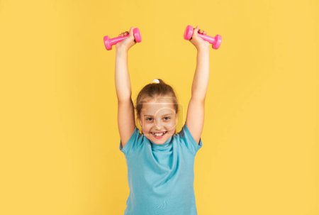 Photo for Sporty girl with dumbbells. Fitness kids, health and energy. Healthy kids lifestyle. Kid exercising with dumbbell. Sport for little children - Royalty Free Image