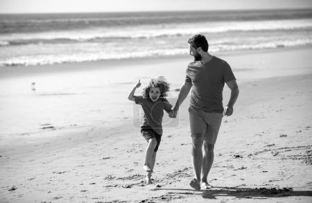 Photo for Dad and child having fun outdoors. Father and son running on summer beach - Royalty Free Image