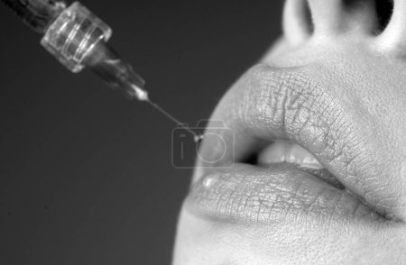 Photo for Closeup of lips augmentation. Syringe female mouth. Cosmetology Treatment. Hyaluronic acid injection. Age changes - Royalty Free Image