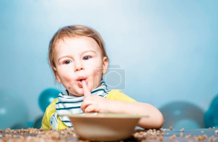 Photo for Babies eating, healthy food for a baby. Funny kid boy with plate and spoon - Royalty Free Image