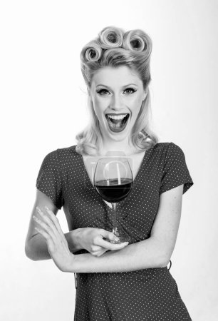 Photo for Happy girl with glass of wine. Beautiful blonde woman in red dress with retro hairstyle. Fashion. Retro woman. Smiling fashionable pinup girl. Beautiful blonde woman in red dress - Royalty Free Image