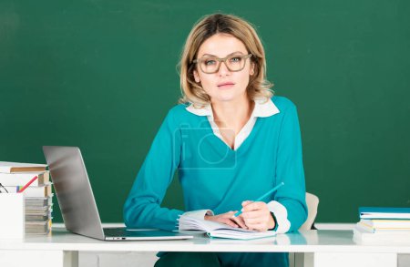 Photo for Education, high school and people concept Portrait of teacher or female tutor working at table in college or high school. Young women student studying in class - Royalty Free Image