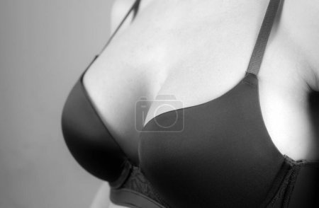 Photo for Sexy woman breast in bra. Closeup girl boob or big natural tits in lingerie. Plastic surgery concept - Royalty Free Image