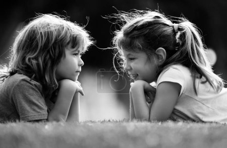 Photo for Kids cute couple in love. Children relationships. Little boy girl outdoors in park - Royalty Free Image