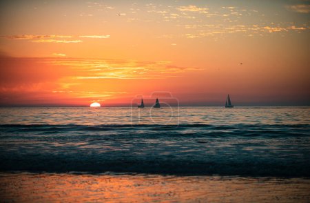Photo for Sailboat at sea. Sunrise over the sea and beautiful cloudscape. Colorful ocean beach sunset - Royalty Free Image