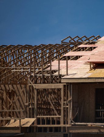 Photo for Roof building. Standard timber framed building with roof trusses. Roof Timber Frame house. The frame of the new build home. Construction site. Roof trusses constructed with construction beams timber - Royalty Free Image
